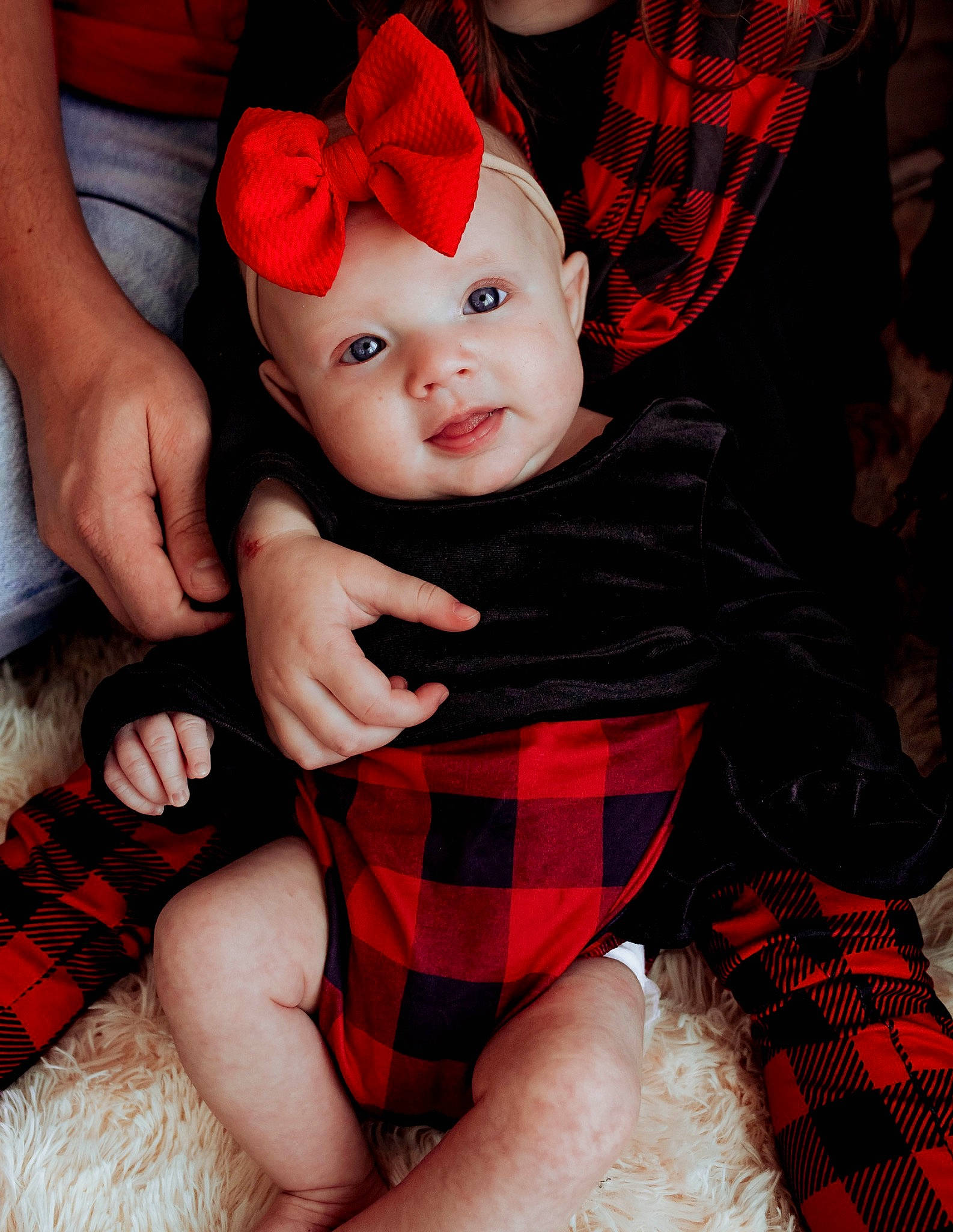 Khloe is registered to the contest to win money with this photo: baby, baby_toddler_clothing, black, cap, child, comfort, design, hat, head, headwear, human_leg, lap, pattern, person, plaid, red, sleeve, sock, tartan, textile