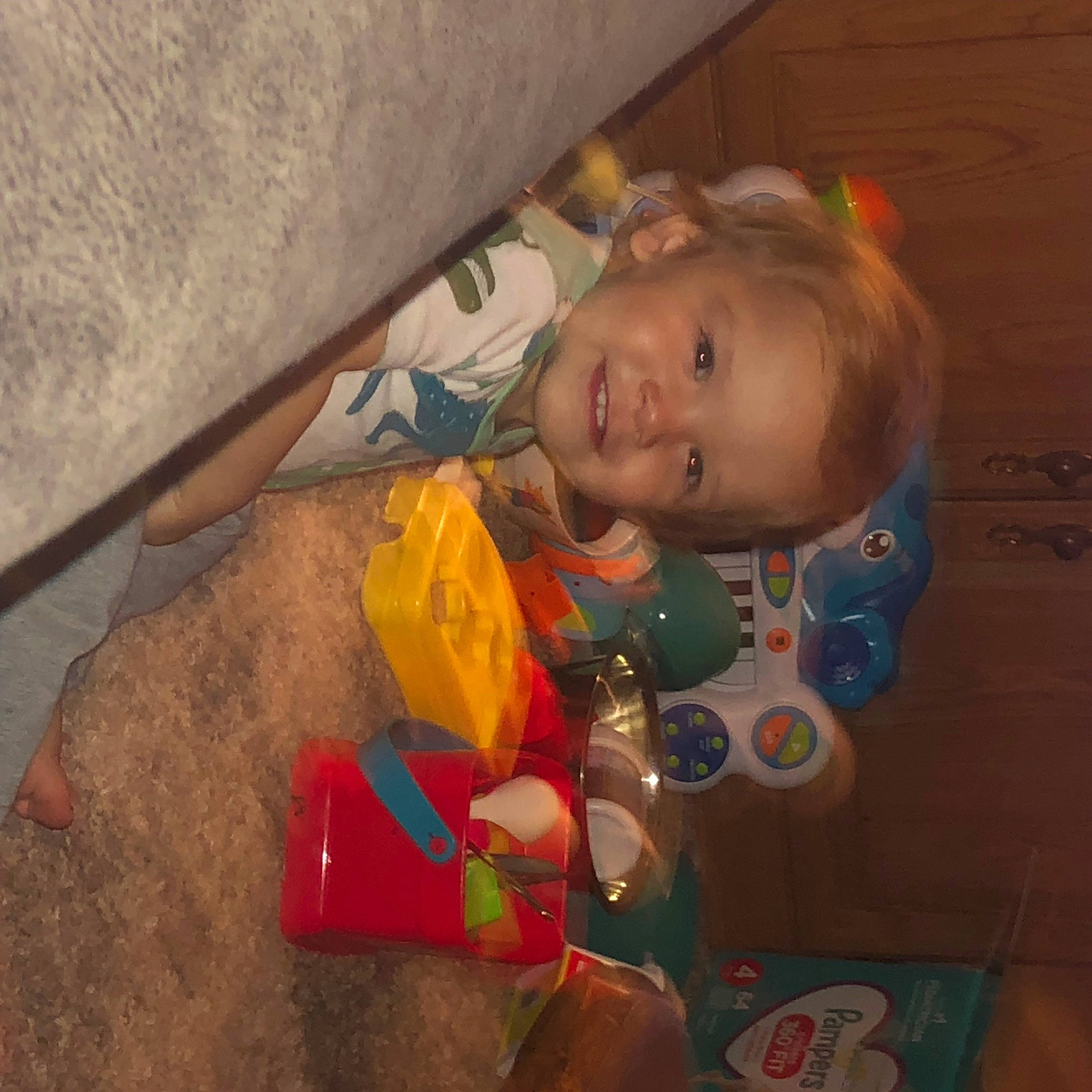 William is registered to the contest to win money with this photo: baby, baby_products, brown, cheek, child, eye, flooring, fun, iris, joy, packing_materials, person, plastic, room, sitting, smile, toddler, toy, wood