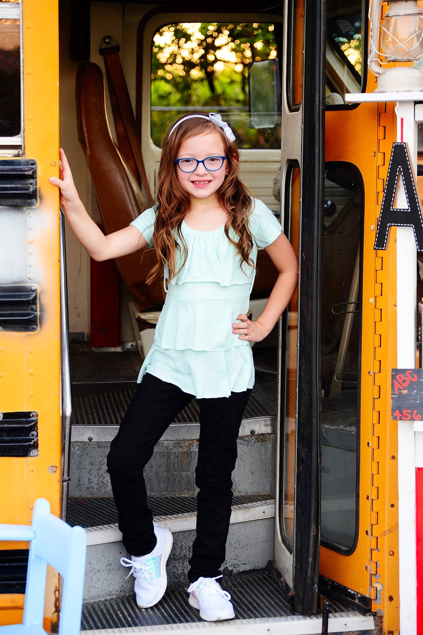 Maddysen is registered to the contest to win money with this photo: child_model, door, fun, jeans, joy, person, photo_shoot, photography, standing, transport, vehicle, yellow