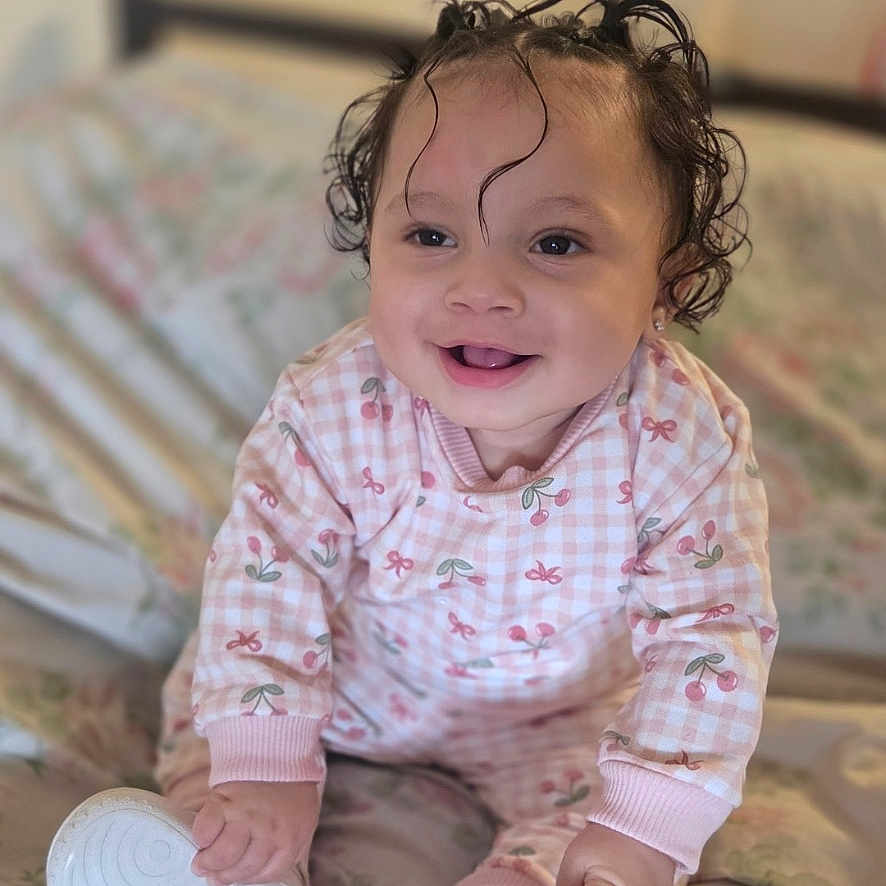 Kallista joined the competition — help win amazing prizes! baby, child, infant, smiling, happy, curly_hair, sitting, bed, bedroom, portrait, indoors, pajamas, pink_clothing, shoes, white_shoes, hands, face, laughter, cozy, photograph