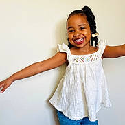 Loyalty joined the competition — help win amazing prizes! arms_outstretched, beads, blue_jeans, braids, casual_clothing, child, cute, embroidery, fashion, girl, hairstyle, happy, indoor, joyful, light_background, portrait, posing, smiling, white_top, youth