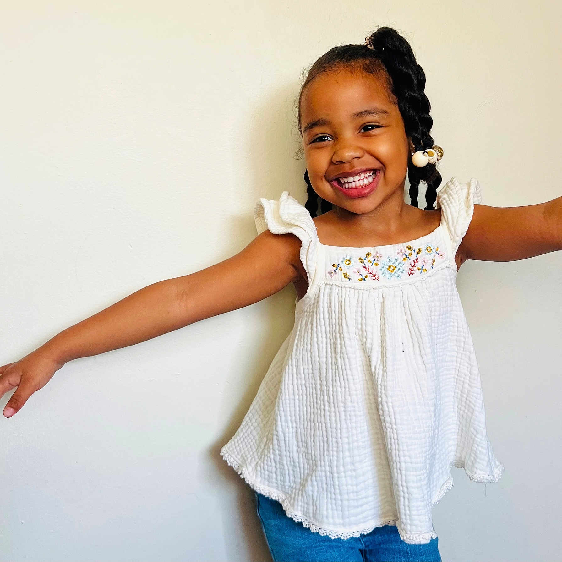Loyalty joined the competition — help win amazing prizes! arms_outstretched, beads, blue_jeans, braids, casual_clothing, child, cute, embroidery, fashion, girl, hairstyle, happy, indoor, joyful, light_background, portrait, posing, smiling, white_top, youth