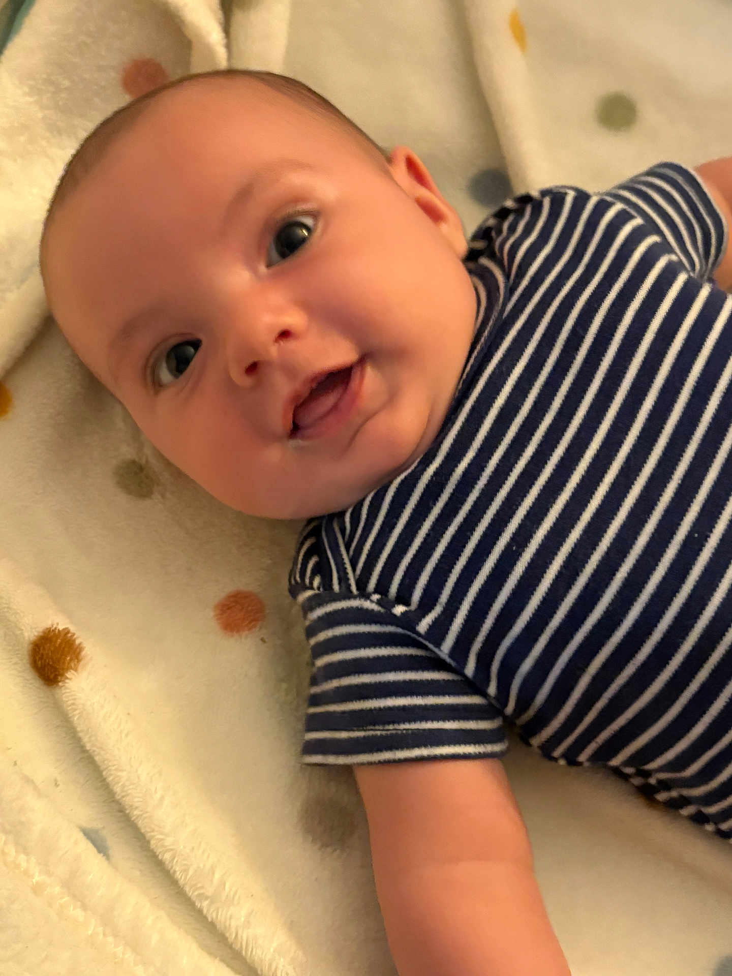 Emerson joined the competition — help win amazing prizes! baby, infant, child, striped_clothing, blanket, polka_dot, smile, face, eyes, arm, lying_down, cute, adorable, soft_texture, indoor, closeup, person, young, happy, comfortable