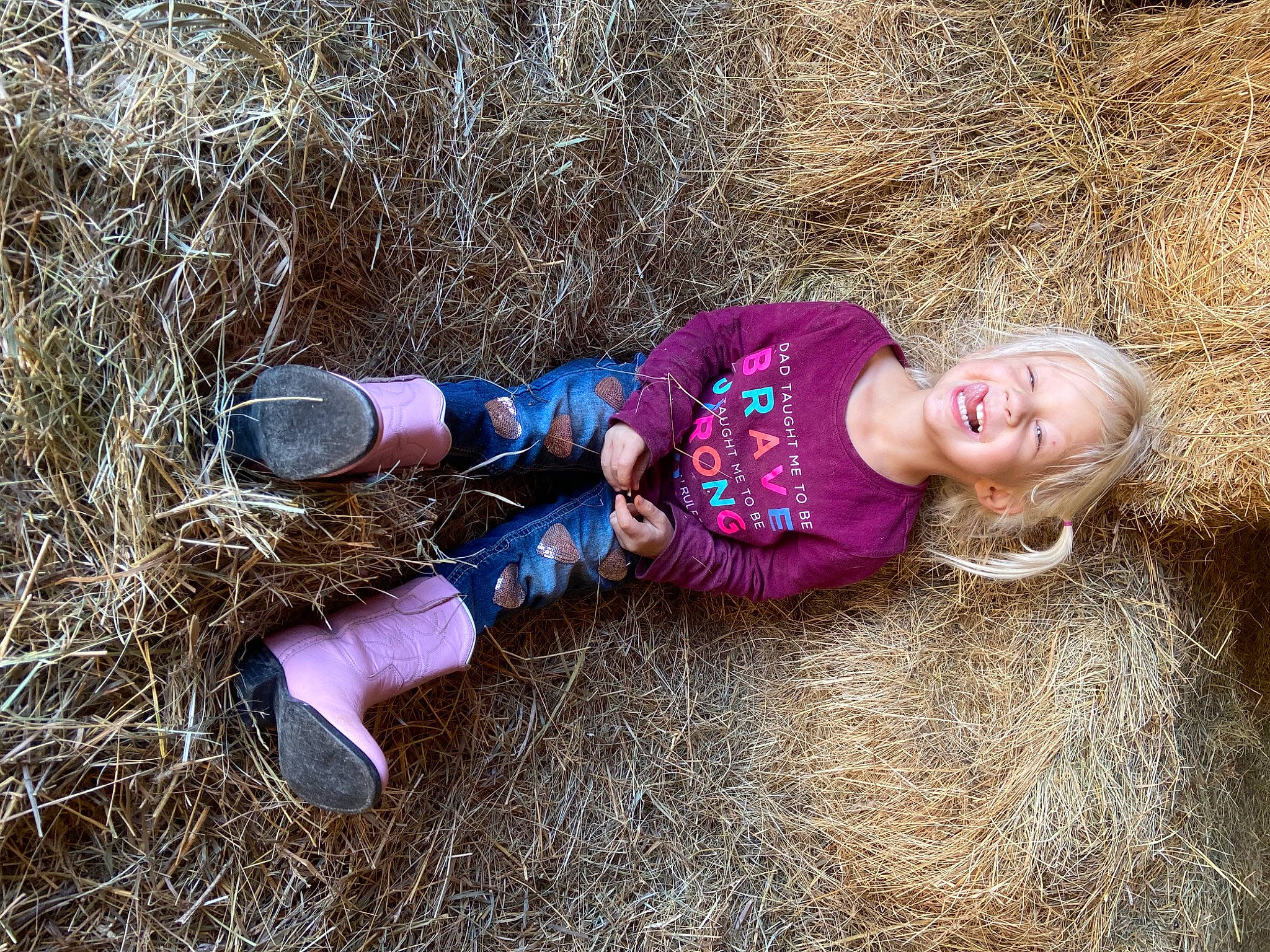 Addyson is registered to the contest to win money with this photo: baby_toddler_clothing, child, fun, fur, grass, grassland, happy, human_leg, joy, landscape, magenta, people_in_nature, person, smile, soil, straw, toddler, tree, vertebrate, winter