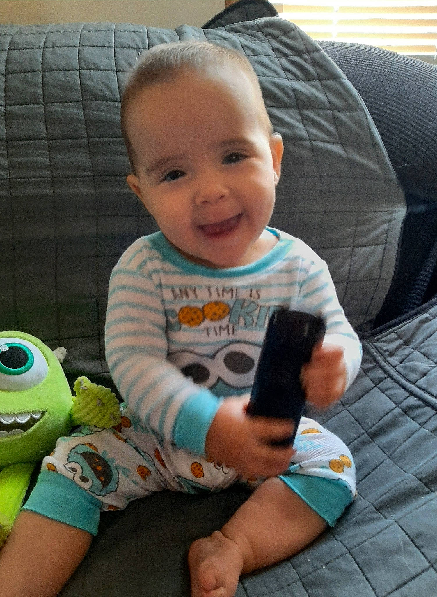 Persephone is registered to the contest to win money with this photo: baby, baby_toddler_clothing, cheek, child, comfort, couch, face, finger, green, hairstyle, hand, happy, head, human, human_body, joy, people, person, product, skin