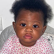 Serena participe au concours pour gagner de l'argent avec cette photo : baby, blanket, child, clothing, cute, expression, eyes, face, hair, indoor, infant, onesie, pattern, person, pink, portrait, sitting, skin, white, young_child