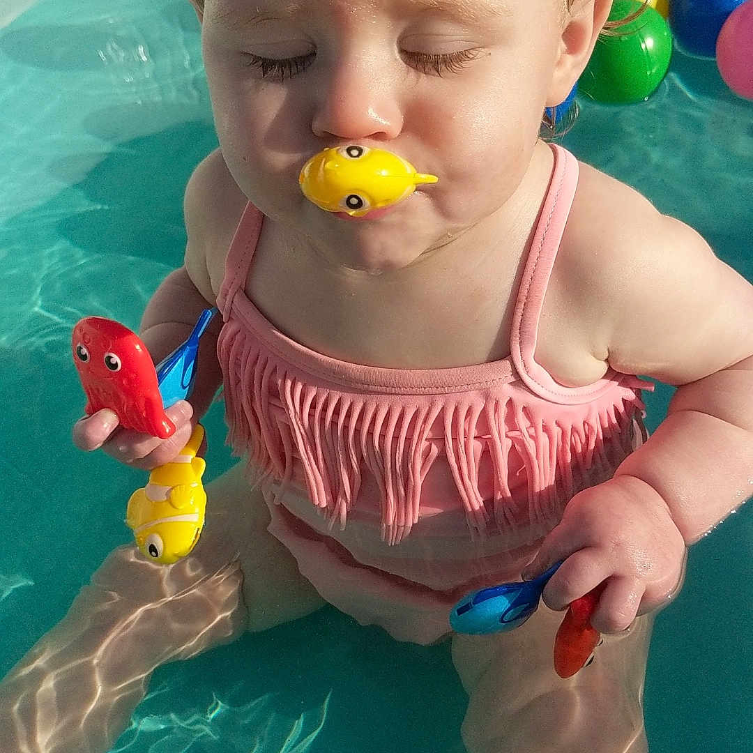 Peyton is registered to the contest to win money with this photo: animal, baby, beak, bird, clothing, face, head, leisureactivities, person, photography, pool, portrait, sport, summer, swimming, swimmingpool, swimwear, toy, water, watersports