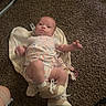 Bexleigh is registered to the contest to win money with this photo: baby, infant, onesie, shoes, blanket, carpet, floor, person, child, indoor, cute, lying_down, clothing, footwear, expression, human, newborn, small, casual, snapshot