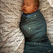 Enzo is registered to the contest to win money with this photo: baby, sleeping, swaddled, blanket, stars, moon, pillow, text, love, cozy, infant, child, bed, rest, cute, peaceful, face, sleep, soft, comfort