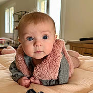Margaux participe au concours pour gagner de l'argent avec cette photo : baby, bed, blanket, blue_eyes, cheeks, child, cozy, crib, face, furniture, fuzzy_vest, hands, home, indoor, infant, lips, looking_at_camera, nose, pink, portrait