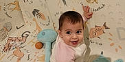 Nelya participe au concours pour gagner de l'argent avec cette photo : animal_print, baby, child, childrens_room, cute, floor, footwear, fun, happy, home, indoor, infant, pink_sleeves, play_mat, playtime, sitting, smiling, soft_toys, toy, white_clothing