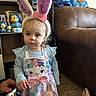 Charlotte joined the competition — help win amazing prizes! toddler, child, indoor, bunny_ears, easter_dress, toy, plush, carpet, couch, hand, phone, foot, stitch, decor, face, person, blue_shirt, pink_bow, curious, apron