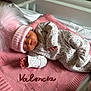 Valencia is registered to the contest to win money with this photo: newborn, baby, sleeping, pink_hat, floral_onesie, blanket, soft_texture, cute, infant, indoors, cozy, portrait, child, resting, knit_blanket, warm_clothing, pink_color, baby_bed, peaceful, sleep