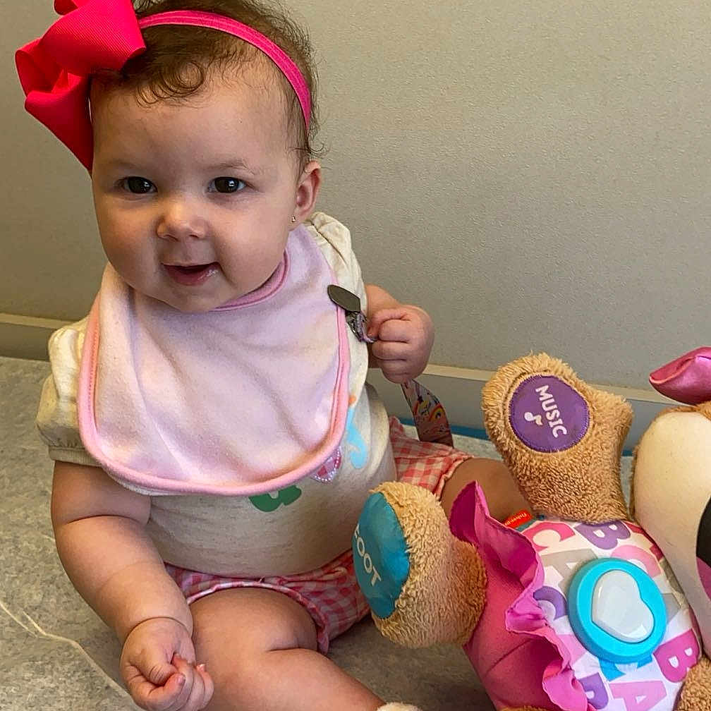 Kylee is registered to the contest to win money with this photo: baby, ball, clothing, costume, cushion, face, football, happy, head, homedecor, hosiery, person, photography, portrait, sitting, soccer, soccerball, sock, tape, toy