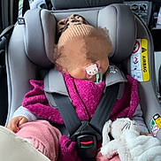 Naomi participe au concours pour gagner de l'argent avec cette photo : baby, car_interior, car_seat, child, clothing, hand, hat, headwear, infant, knitwear, pacifier, pink, purple, safety, seatbelt, sleeping, soft_toy, stuffed_animal, toy, transportation