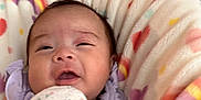 Celia joined the competition — help win amazing prizes! baby, blanket, child, comfort, cozy, cute, expression, face, hearts, indoor, infant, mittens, newborn, person, portrait, purple_clothing, rainbow, resting, soft, wrapped