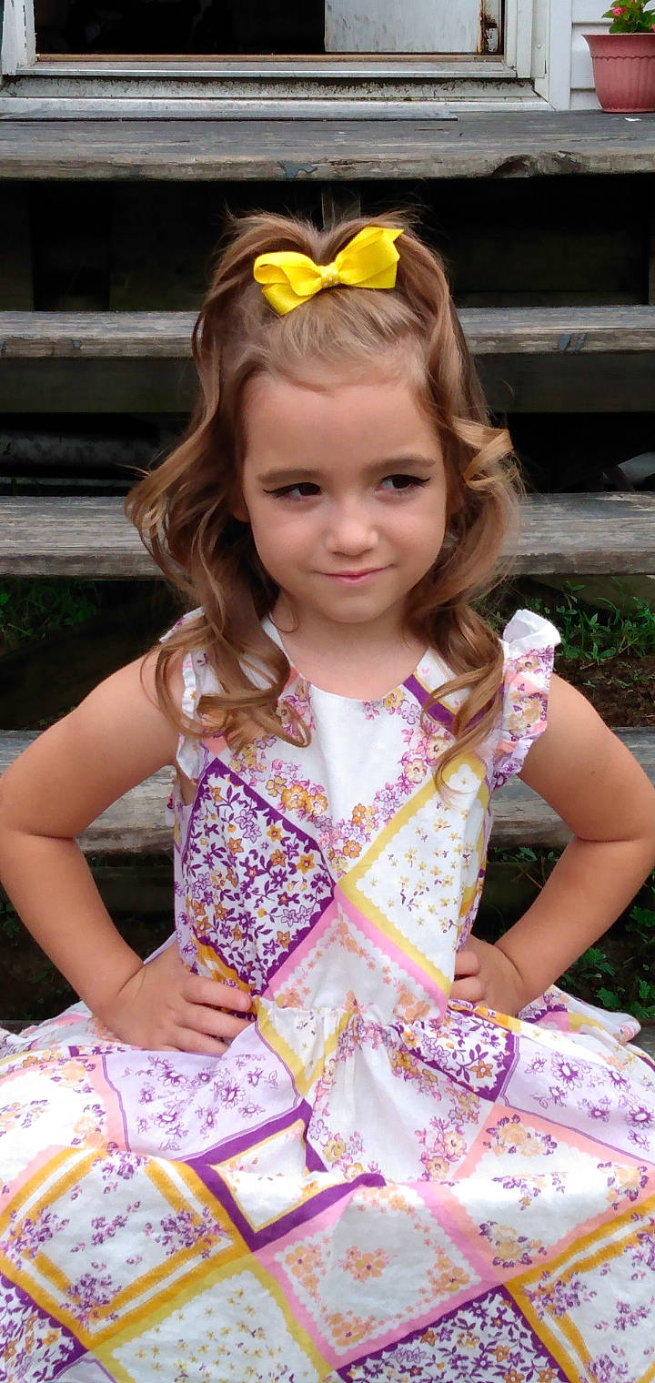 Harley joined the competition — help win amazing prizes! beauty, blond, child, dress, event, face, fawn, fun, grass, hairstyle, happy, head, joy, person, pink, plant, skin, smile, summer, textile