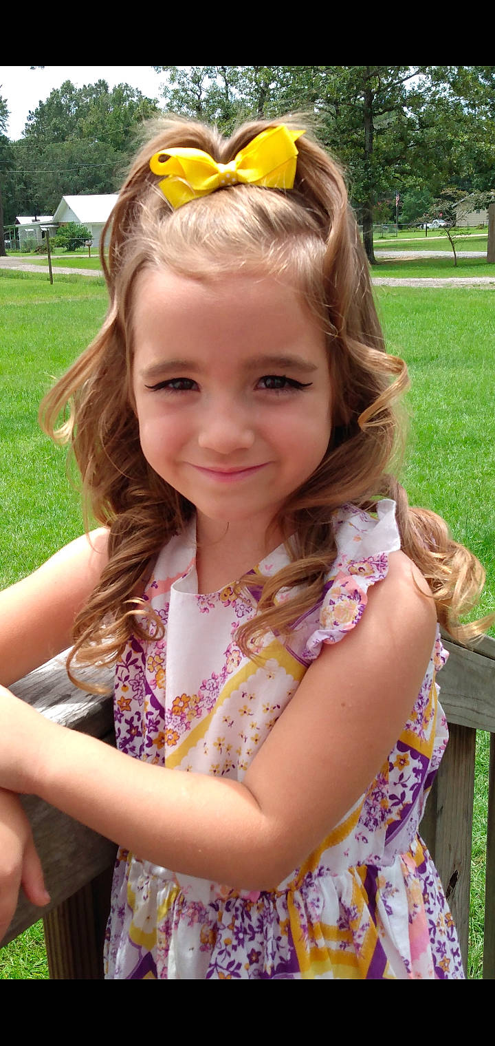 Harley is registered to the contest to win money with this photo: botany, face, facial_expression, fawn, fun, goggles, grass, green, hair, hairstyle, happy, iris, joy, leaf, lip, neck, organ, person, pink, plant