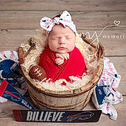 Gabriella joined the competition — help win amazing prizes! newborn, baby, sleeping, portrait, football, sports_fan, red_clothing, headband, bow, wooden_barrel, rustic, blanket, curly_fur, sports_gear, helmet, sign, wooden_floor, photography, peaceful