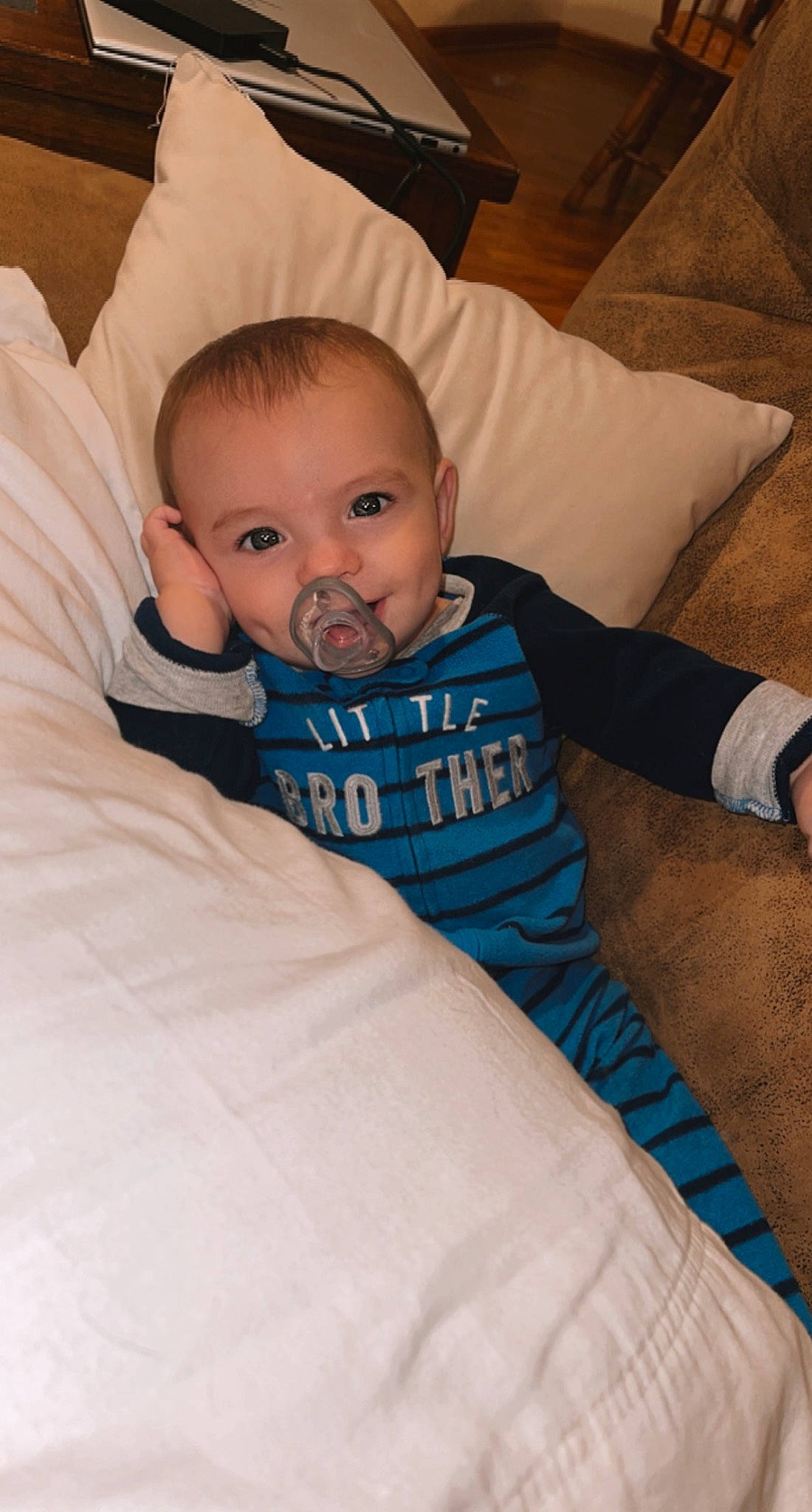 Rhett is registered to the contest to win money with this photo: baby, baby_toddler_clothing, cheek, child, comfort, couch, eye, face, finger, hand, happy, head, iris, linens, person, sitting, skin, sleeve, smile, t_shirt