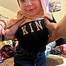 toddler, child, smiling, hoodie, jeans, hands, indoor, carpet, toy, poster, kitten, person, clothing, happy, face, cute, home, playful, baby, portrait