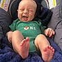 Coda joined the competition — help win amazing prizes! baby, infant, smiling, laughing, car_seat, green_onesie, fox_graphic, blue_blanket, cozy, cushion, happy, feet, toes, head, face, person, child, indoor, natural_light, comfort