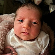 Daisy Suelynn is registered to the contest to win money with this photo: baby, newborn, infant, face, pacifier, blanket, white_clothing, closeup, portrait, cute, soft, pink, child, young, wrapped, indoors, skin, head, eyes, expression