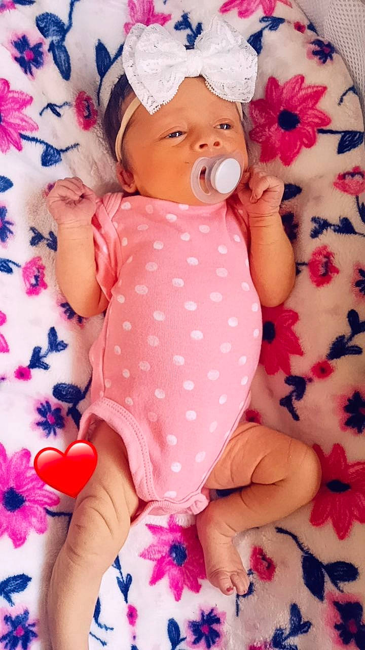 Bailey is registered to the contest to win money with this photo: arm, baby, baby_sleeping, baby_toddler_clothing, cheek, child, comfort, finger, gesture, hand, headwear, mouth, nail, pattern, person, pink, skin, sleeve, textile, thumb