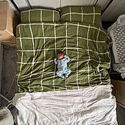 Arlo joined the competition — help win amazing prizes! baby, bed, blanket, blue_onesie, child, crib, fabric, furniture, green_bedding, head, indoor, infant, linen, pillow, sleeping, small, soft, toddler, white_blanket, young_child