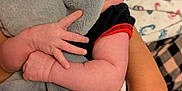 Eleanna is registered to the contest to win money with this photo: arms, baby, black_shirt, blanket, close_up, clothing, comfort, elephant, face, fingers, hand, holding, indoor, infant, looking_away, person, plush_toy, red_trim, skin, soft_toy