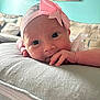 Eleanna is registered to the contest to win money with this photo: baby, child, closeup, comfortable, cozy, cushion, cute, expression, face, hand, headband, indoor, infant, newborn, person, pink_bow, portrait, resting, skin, soft_light