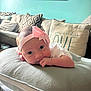 Eleanna is registered to the contest to win money with this photo: baby, child, couch, cozy, cushion, cute, decor, eyes, face, hand, headband, home, infant, living_room, pillow, pink_bow, portrait, resting, soft, text_on_pillow