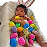 baby, infant, bunny_ears, easter_eggs, colorful, plastic_eggs, blanket, cute, holiday, spring, decorative_grass, indoors, soft_texture, newborn, lying_down, skin, foot, hand, curious, portrait