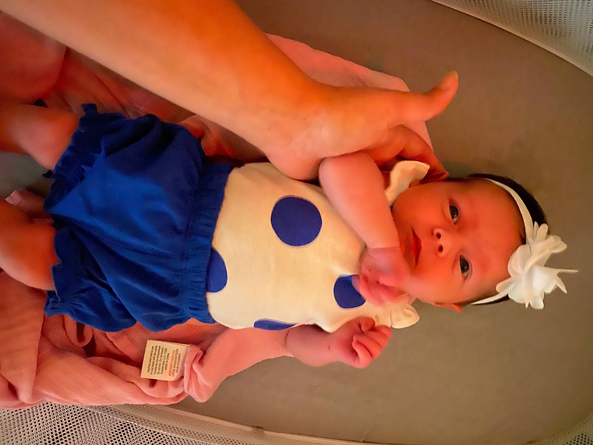 Lakyn is registered to the contest to win money with this photo: arm, baby, baby_toddler_clothing, child, comfort, elbow, finger, gesture, hand, human_body, joint, nail, orange, person, product, skin, stomach, textile, thumb, toddler