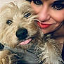 Cookie is registered to the contest to win money with this photo: woman, dog, pet, close_up, face, tongue_out, cuddle, smile, makeup, black_hair, fur, indoor, happy, affection, portrait, cute, animal, friendly, furry, companion