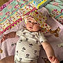 Ayla is registered to the contest to win money with this photo: baby, infant, child, onesie, hat, polka_dot, blanket, floor, pattern, minnie_mouse, cloth, cute, skin, hand, face, expression, indoor, soft, colorful, playful