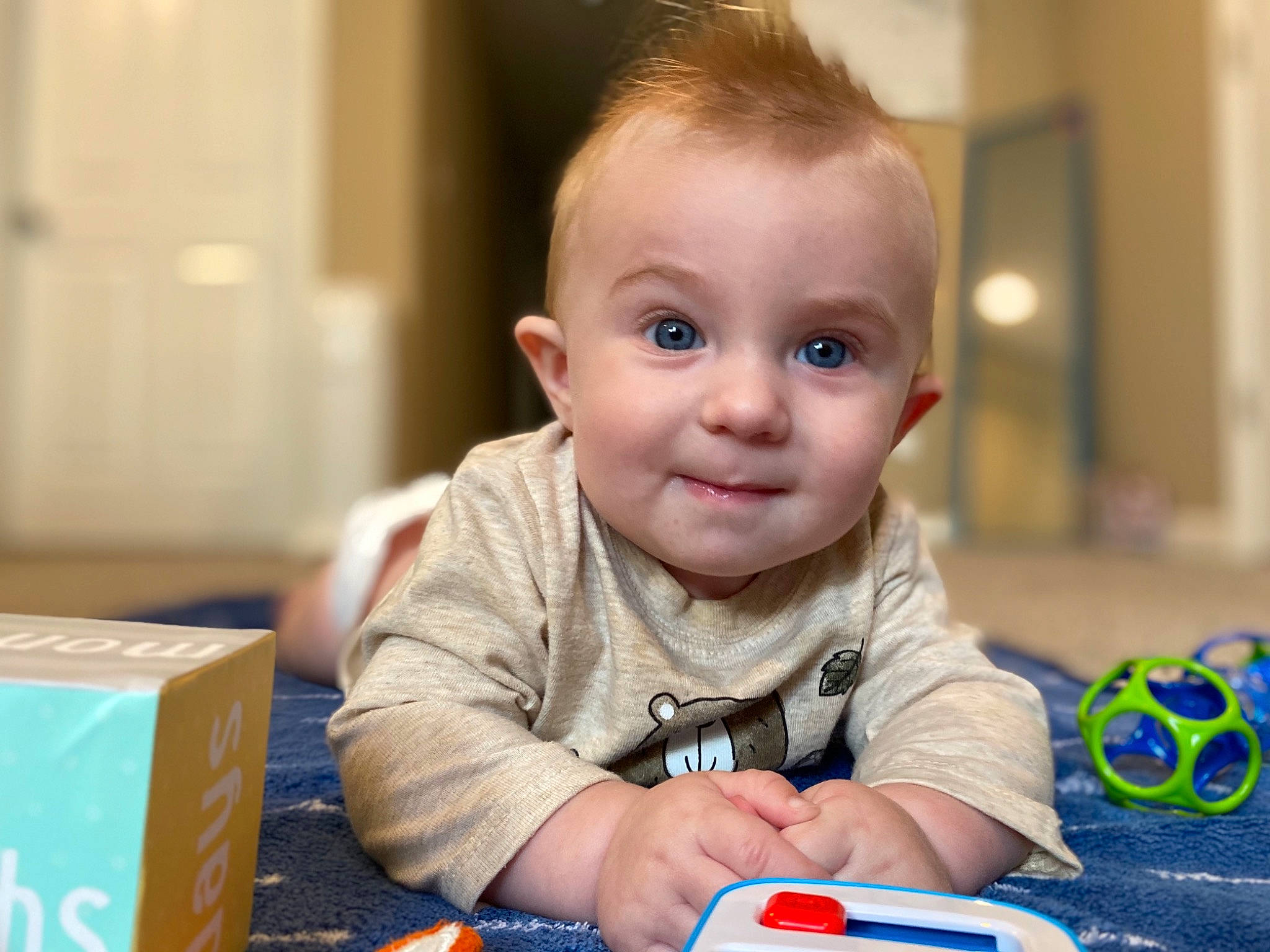 Trevor joined the competition — help win amazing prizes! baby, baby_playing_with_toys, cheek, child, ear, eye, face, joy, learning, person, play, sitting, smile, toddler, toy, tummy_time