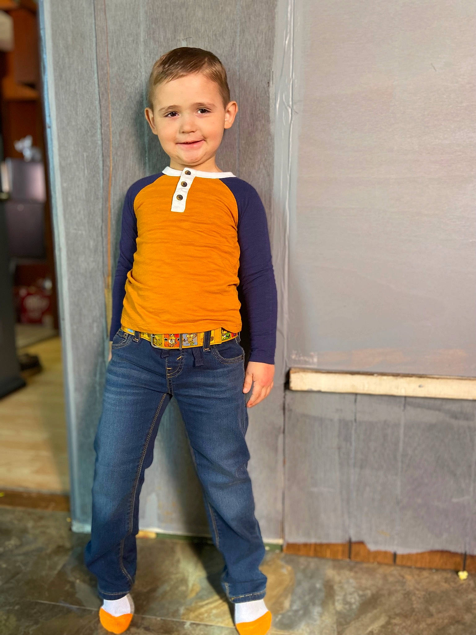 Zane is registered to the contest to win money with this photo: belt, blazer, denim, electric_blue, face, fashion_accessory, fashion_design, flooring, formal_wear, grey, hair, jeans, joy, person, pocket, sleeve, sportswear, t_shirt, toddler, top