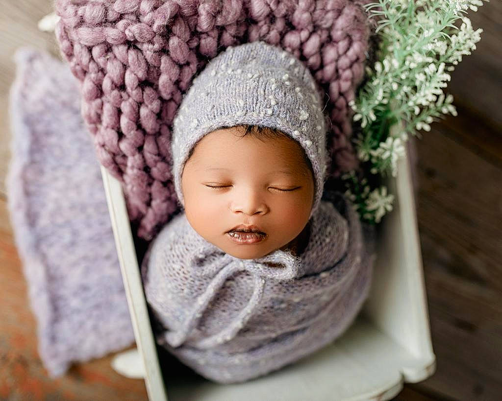 Aaliyah is registered to the contest to win money with this photo: baby, baby_products, baby_sleeping, baby_toddler_clothing, cap, cheek, comfort, eye, face, fashion_accessory, hair_accessory, headgear, headwear, human_body, knit_cap, person, pink, textile, toddler, wood