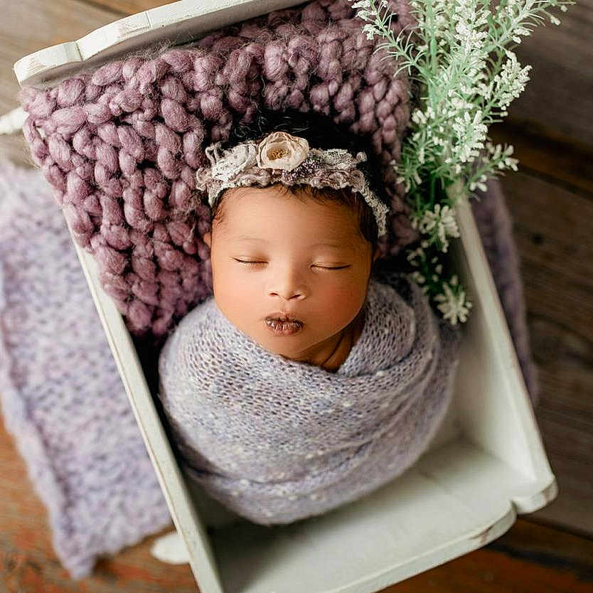 Aaliyah is registered to the contest to win money with this photo: baby, baby_toddler_clothing, cap, costume_hat, eye, face, grass, hair_accessory, happy, head, headband, headgear, headpiece, jewellery, knit_cap, ornament, plant, toddler, wood, wool