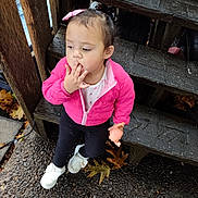 Debani is registered to the contest to win money with this photo: toddler, child, pink_jacket, white_shoes, doll, wooden_steps, autumn_leaves, outdoor, curly_hair, pebble_stone, thoughtful, person, casual_clothing, fall_season, young_child, cute, small_toy, nature, daylight, curious