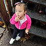 toddler, child, pink_jacket, white_shoes, doll, wooden_steps, autumn_leaves, outdoor, curly_hair, pebble_stone, thoughtful, person, casual_clothing, fall_season, young_child, cute, small_toy, nature, daylight, curious