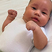 Abdullokhon is registered to the contest to win money with this photo: baby, infant, child, face, fists, white_clothing, lying_down, skin, cheeks, expression, person, cute, newborn, portrait, indoors, closeup, head, young, resting, soft_background