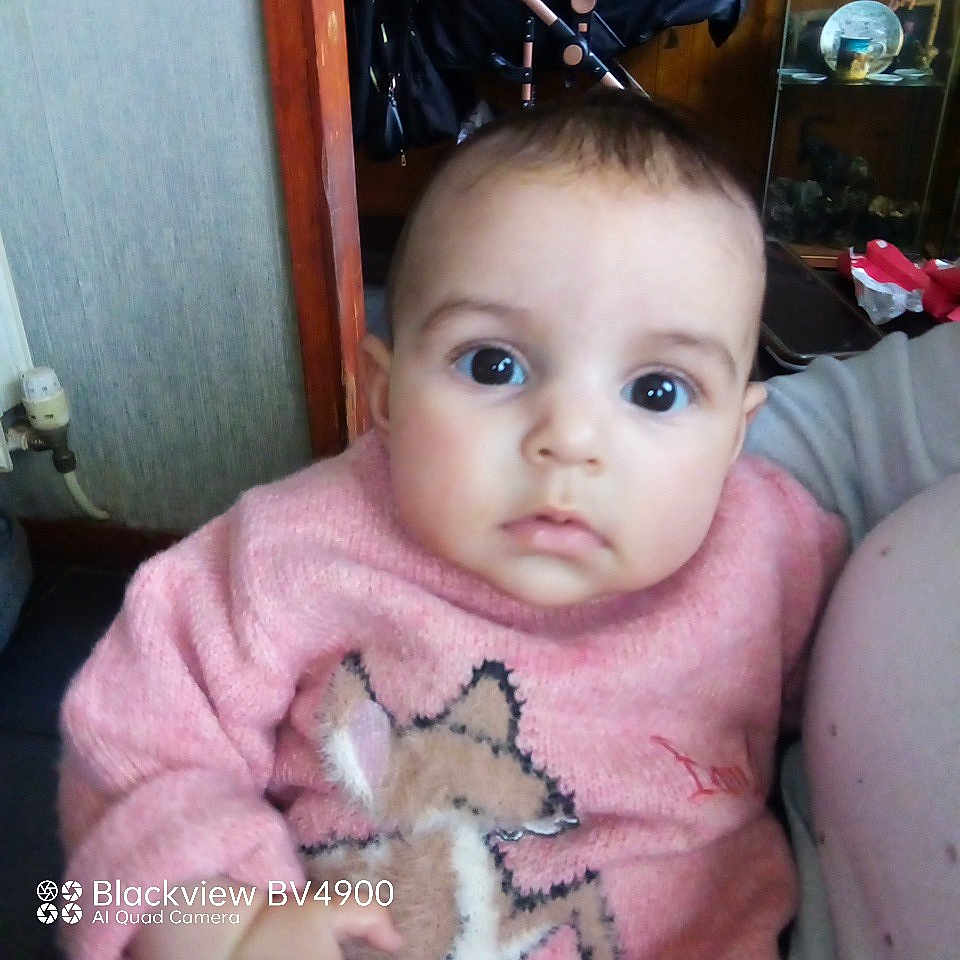 Evie is registered to the contest to win money with this photo: accessories, baby, bag, cabinet, clothing, couch, face, furniture, handbag, head, homedecor, indoors, knitwear, person, photography, portrait, selfie, sitting, sweater, t_shirt