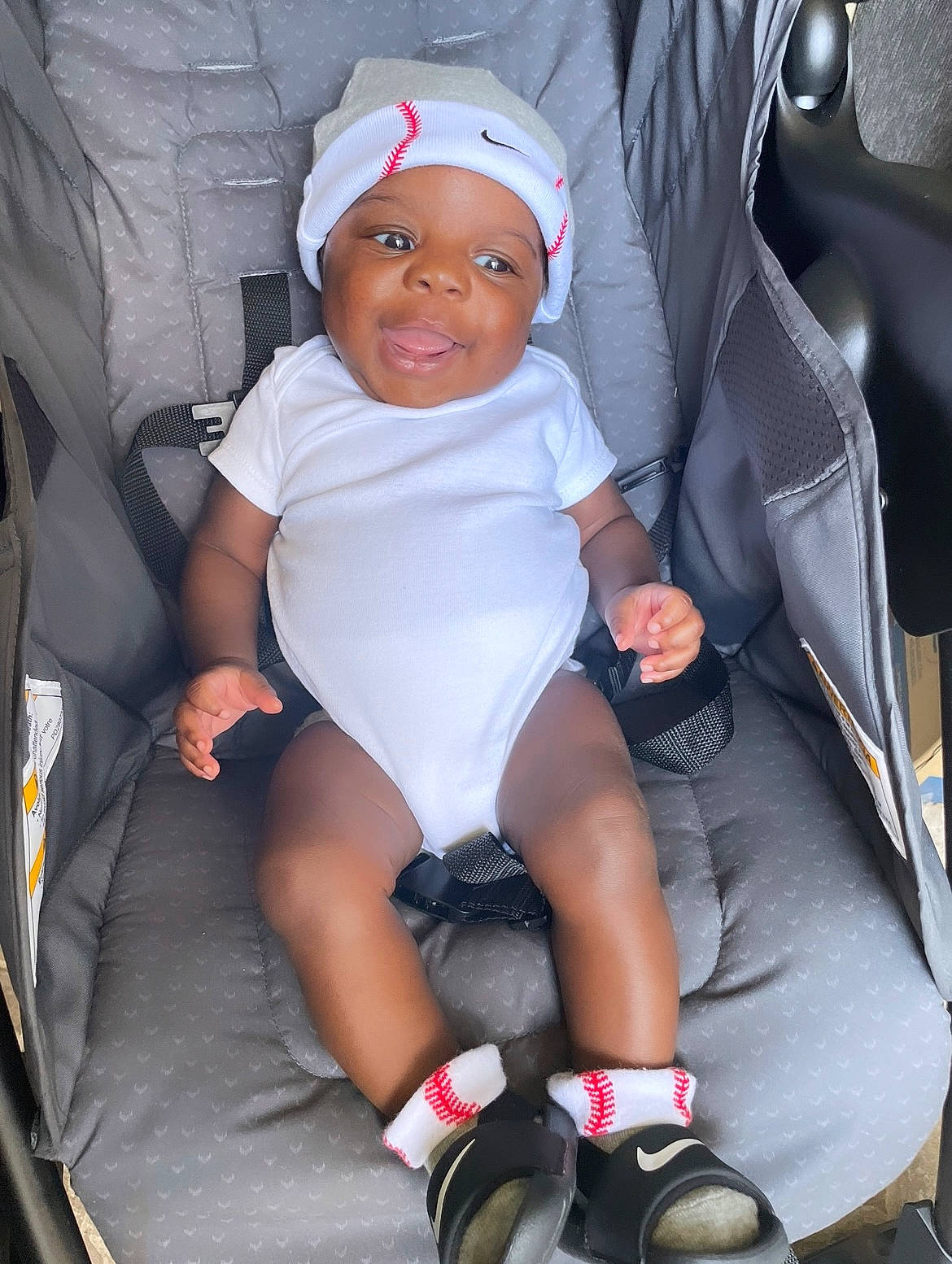 Amiri joined the competition — help win amazing prizes! auto_part, automotive_design, baby, baby_carriage, baby_toddler_clothing, cap, car_seat, child, comfort, fun, headwear, human_leg, lap, leg, person, seat_belt, service, smile, sock, thigh