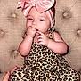Maisey joined the competition — help win amazing prizes! baby, infant, child, headband, pink, velvet, bow, leopard_print, outfit, socks, striped_socks, hand, fingers, sucking, chair, tufted_chair, beige, cute, portrait, indoor