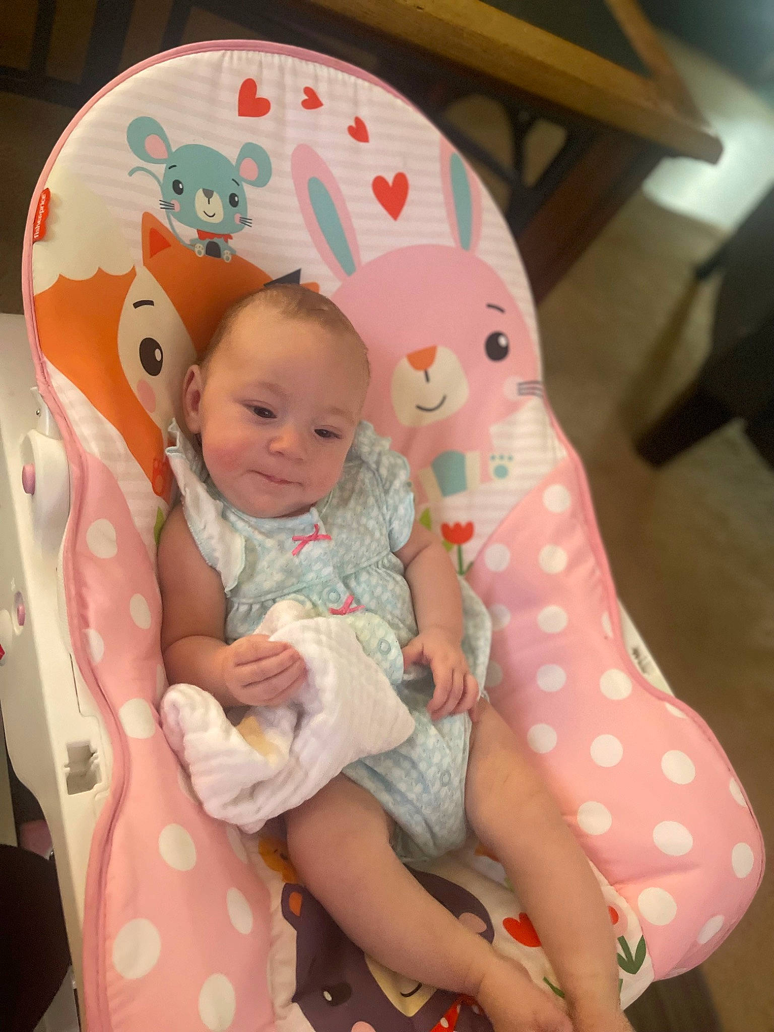 Adalynn is registered to the contest to win money with this photo: baby, baby_products, baby_toddler_clothing, chair, cheek, child, comfort, finger, human_body, human_leg, lap, linens, pattern, person, pink, sitting, skin, smile, sock, thigh