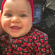 Becky joined the competition — help win amazing prizes! baby, child, smiling, face, headband, bow, red, floral_pattern, clothing, portrait, happy, cute, infant, indoors, person, skin, hand, bright_eyes, closeup, fashion