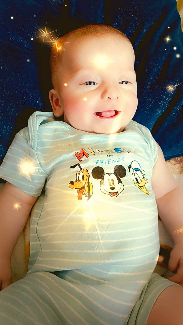 Jayden joined the competition — help win amazing prizes! baby, bodypart, clothing, cushion, face, finger, furniture, hand, happy, head, homedecor, light, lighting, pants, person, photography, portrait, sitting, smile, t_shirt