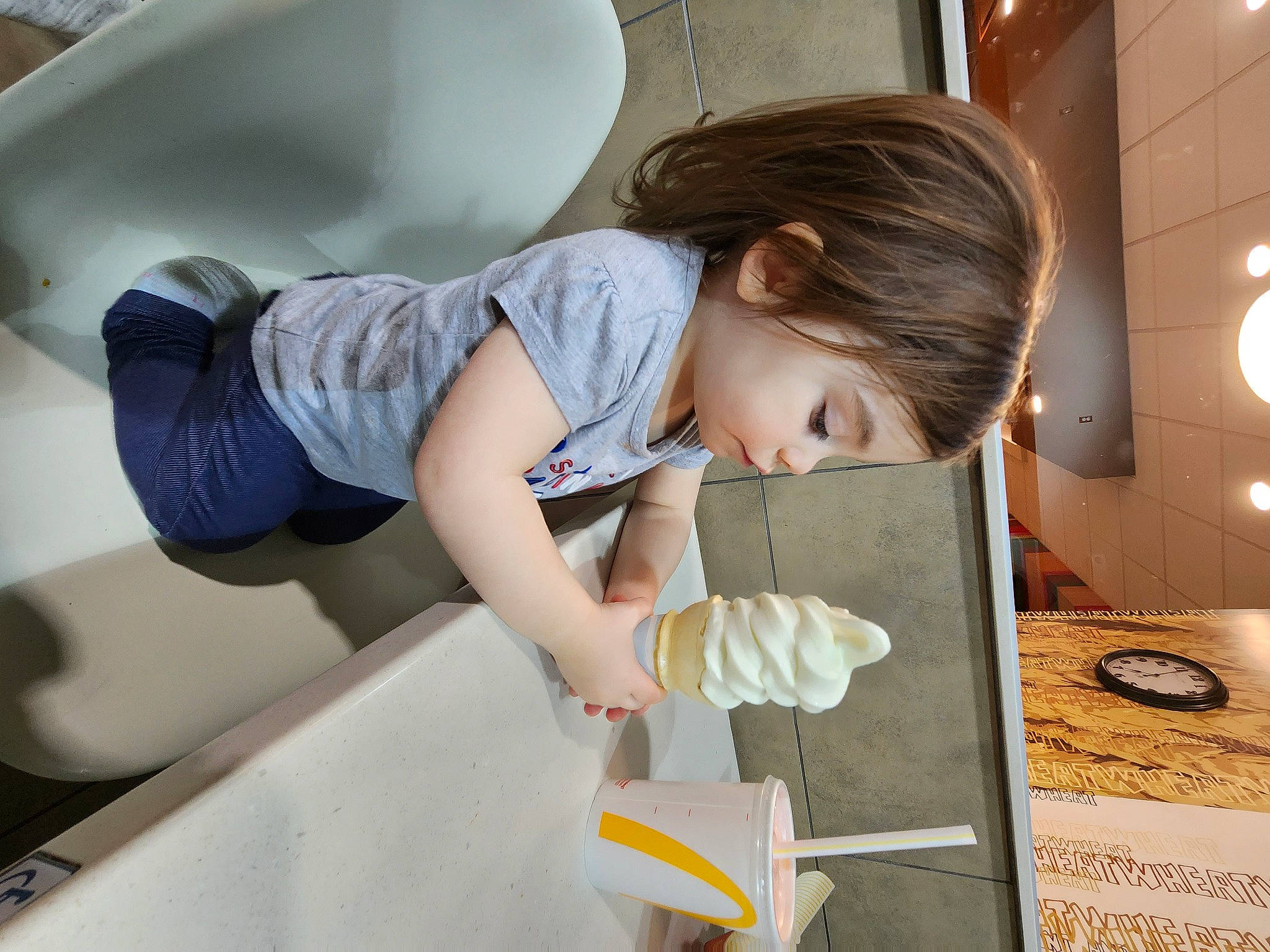 Ryder is registered to the contest to win money with this photo: arm, automotive_design, baby, child, comfort, elbow, flooring, human_leg, knee, person, room, service, sitting, t_shirt, toddler, vehicle_door, wood